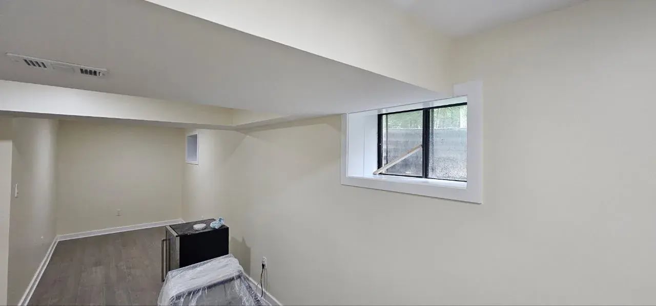 Finished basement room with window