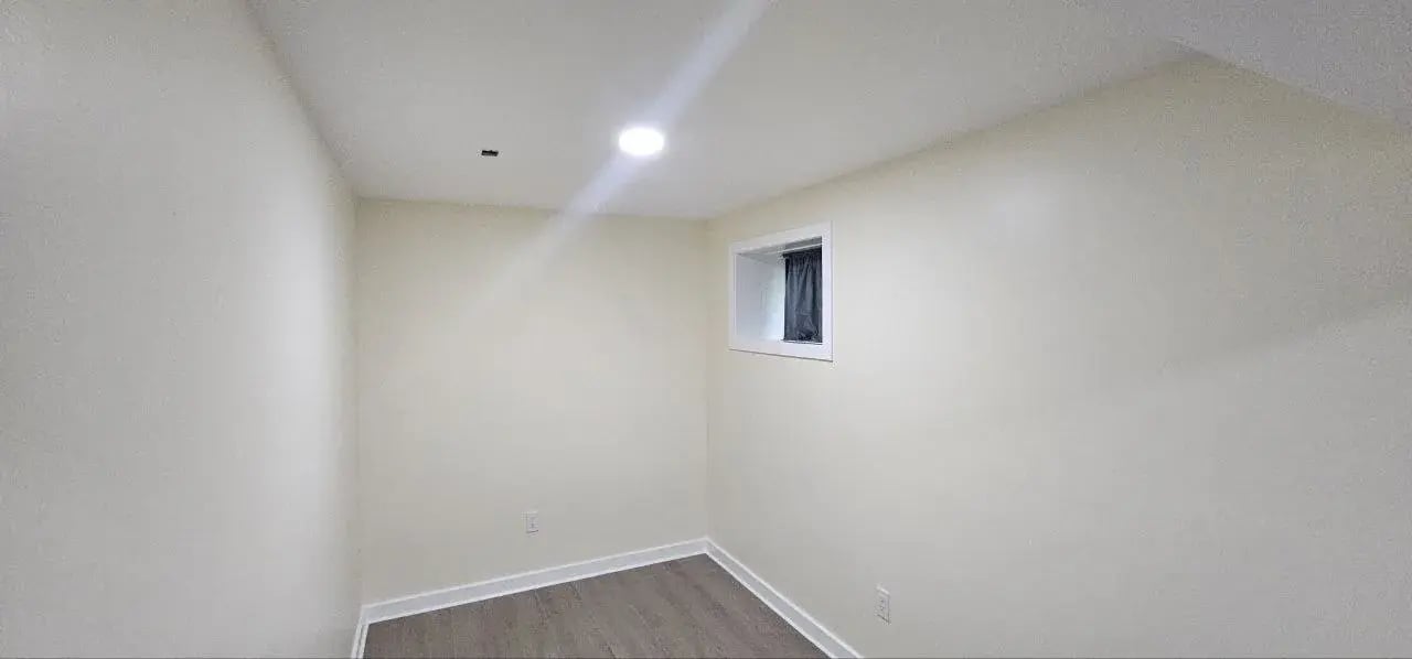 Finished basement room with recessed lights