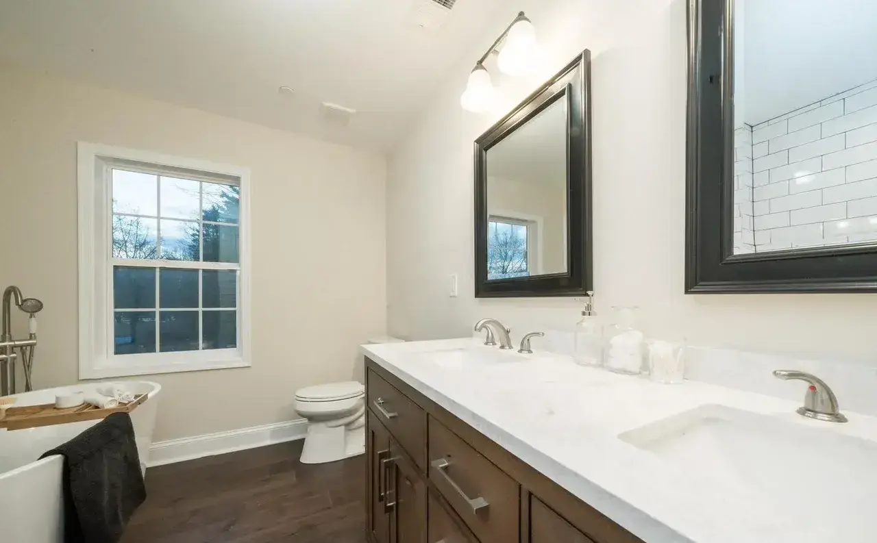 Remodeled bathroom in Solomons, MD with wood vanity and new flooring
