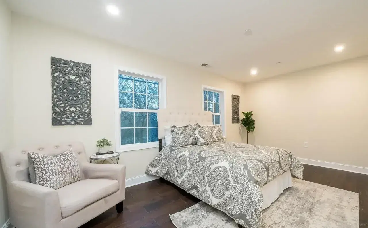 Renovated bedroom in Solomons, MD with recessed lighting and dark wood floors