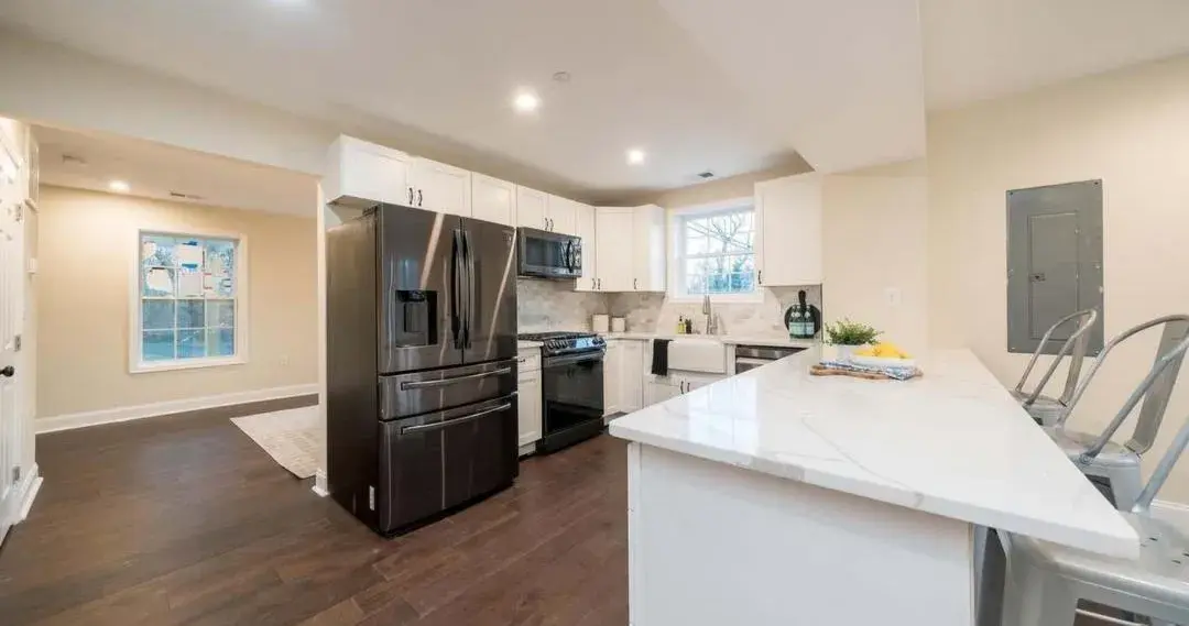 Remodeled kitchen in Solomons, MD with white cabinets and stainless appliances