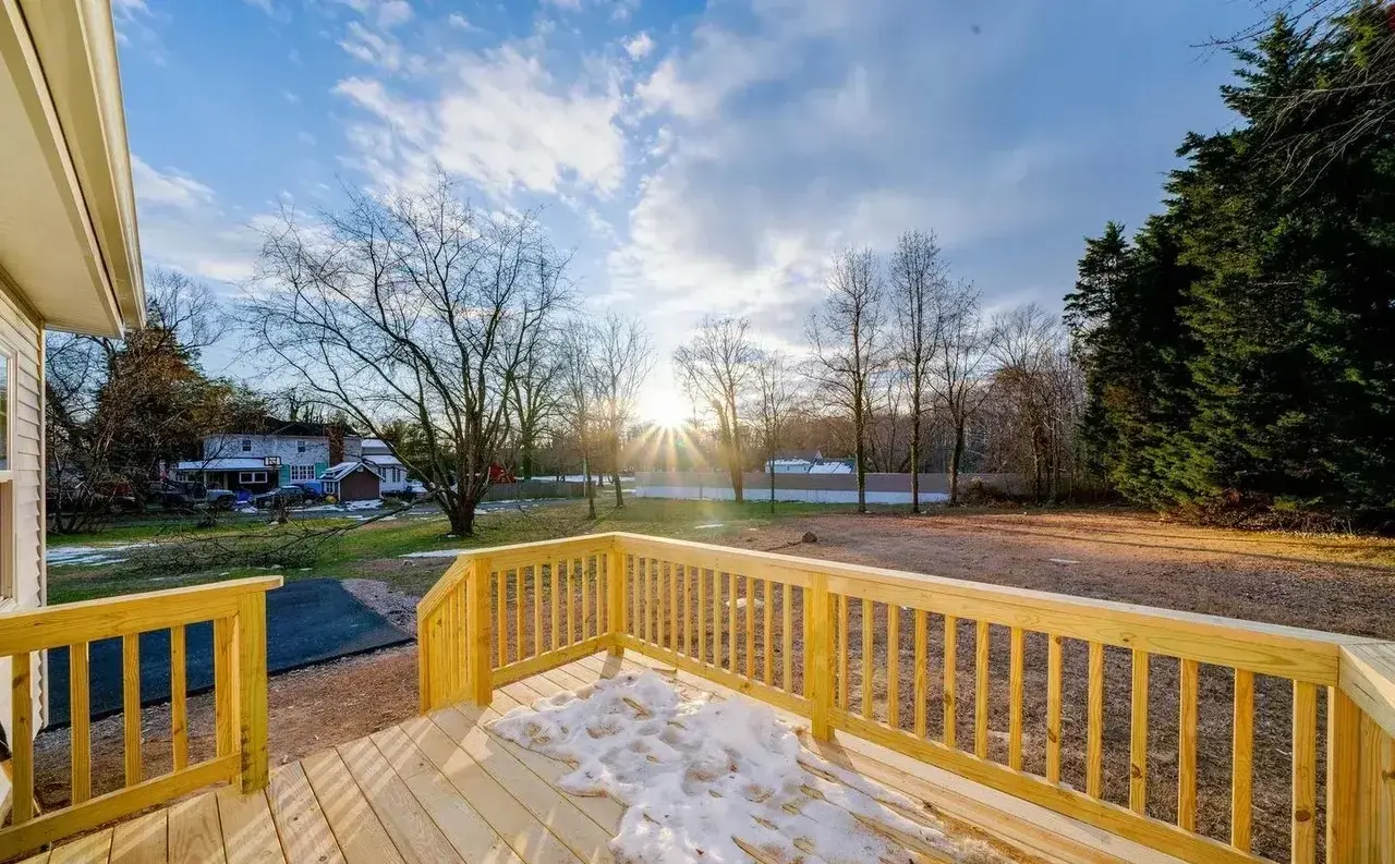 New pressure-treated wood deck with railings overlooking the backyard