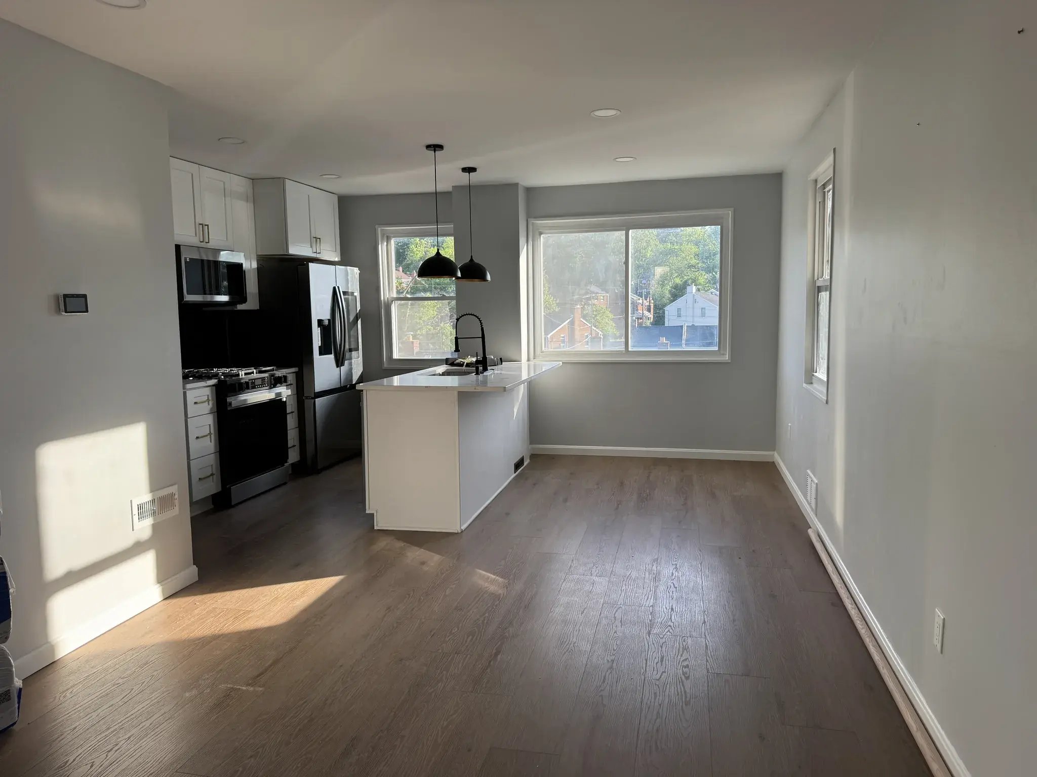 Open kitchen and dining area with new flooring and recessed lights