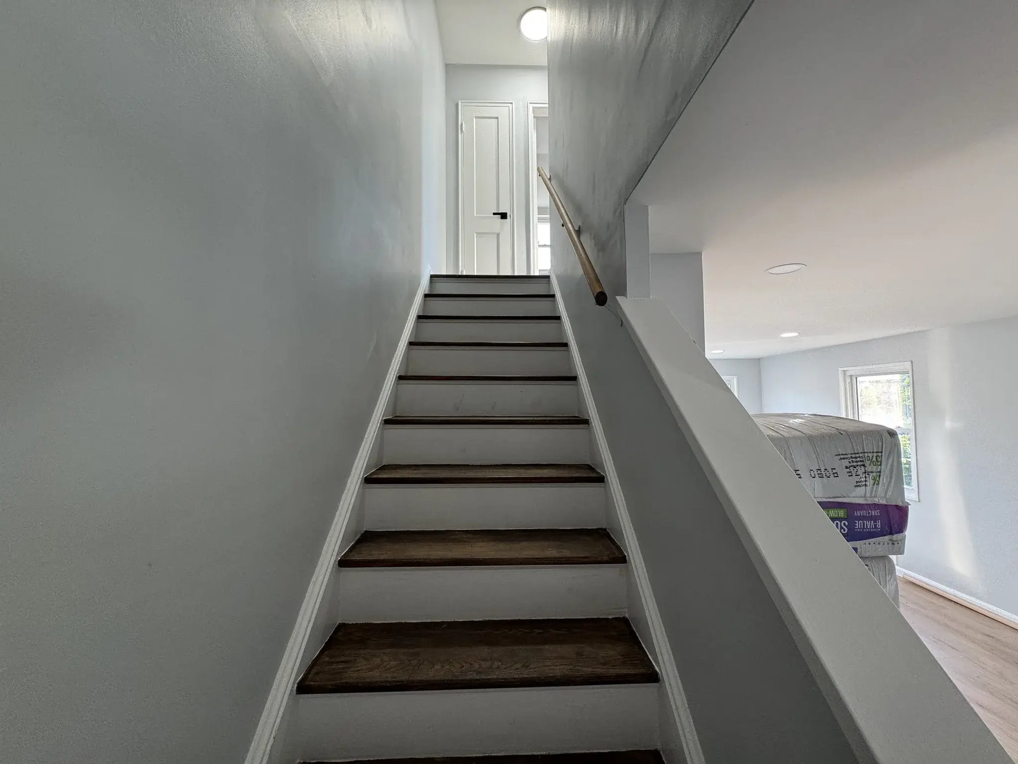 Refreshed staircase with white risers and dark treads