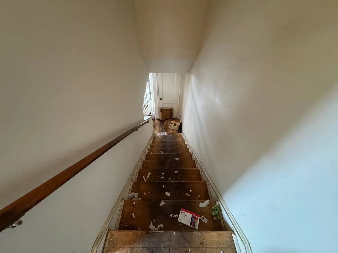 Stairs covered in debris before the cleanout