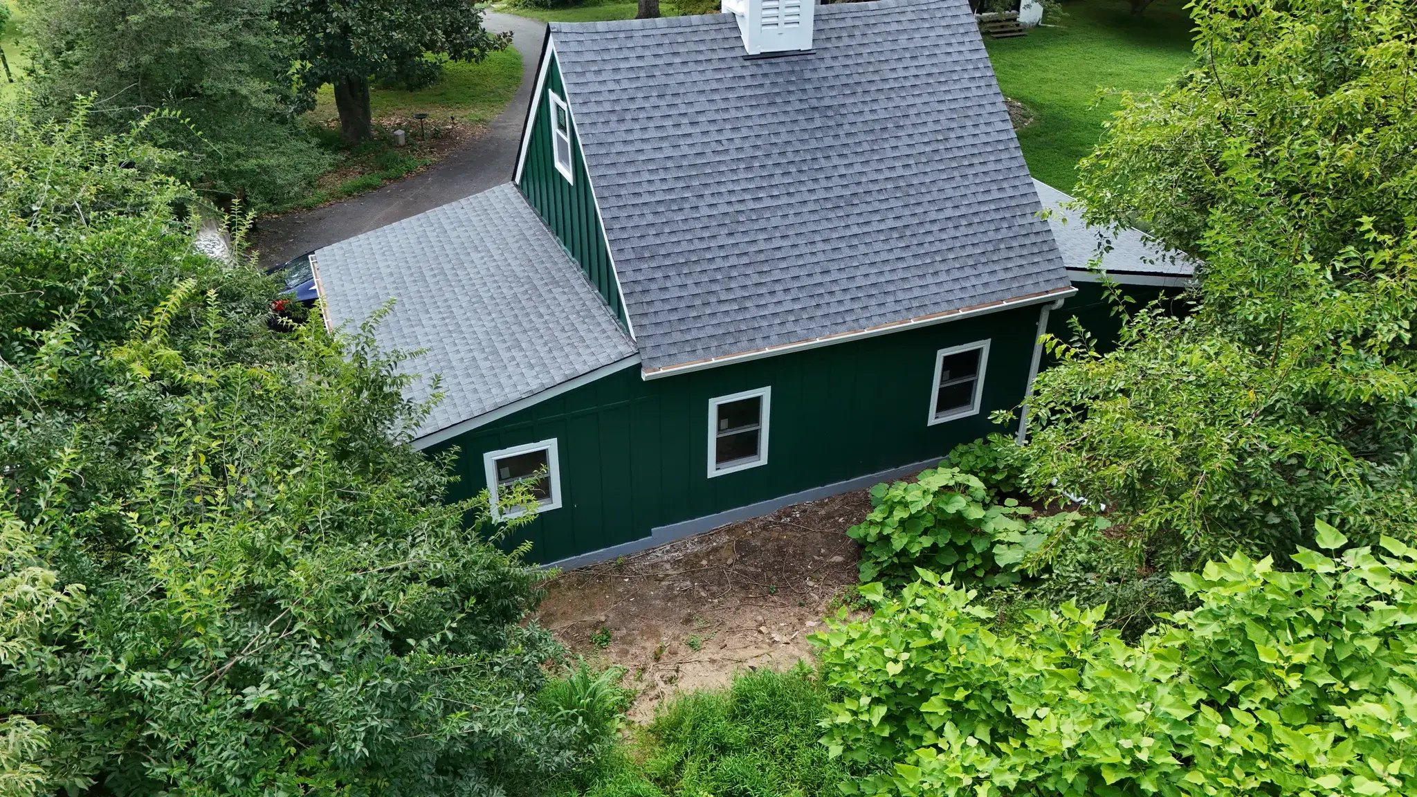 Aerial view of the new garage roof and green siding