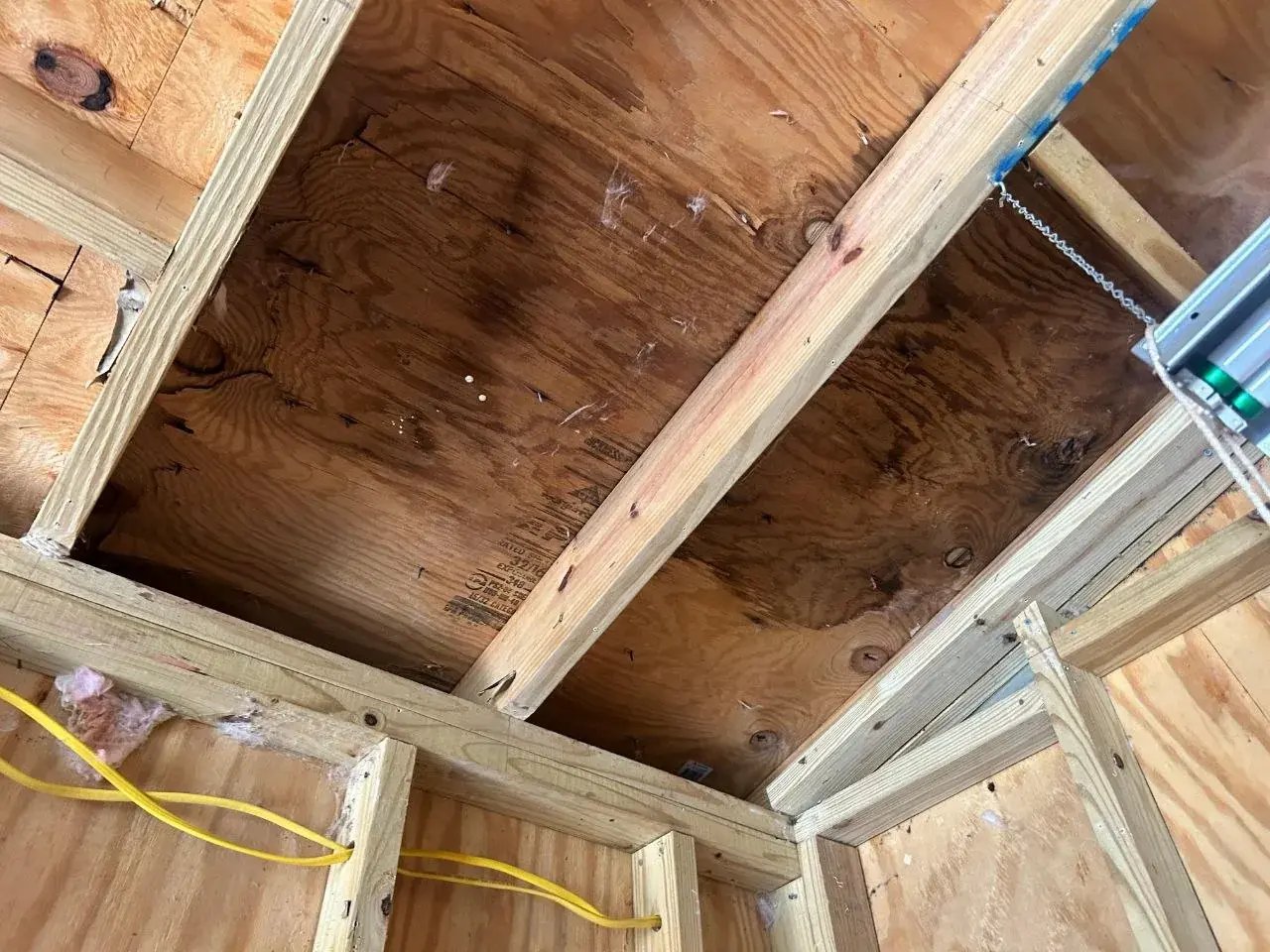 Water-damaged roof sheathing inside the garage