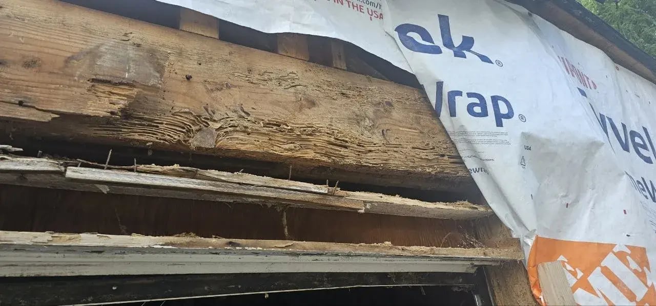 Rot in the header above the garage door