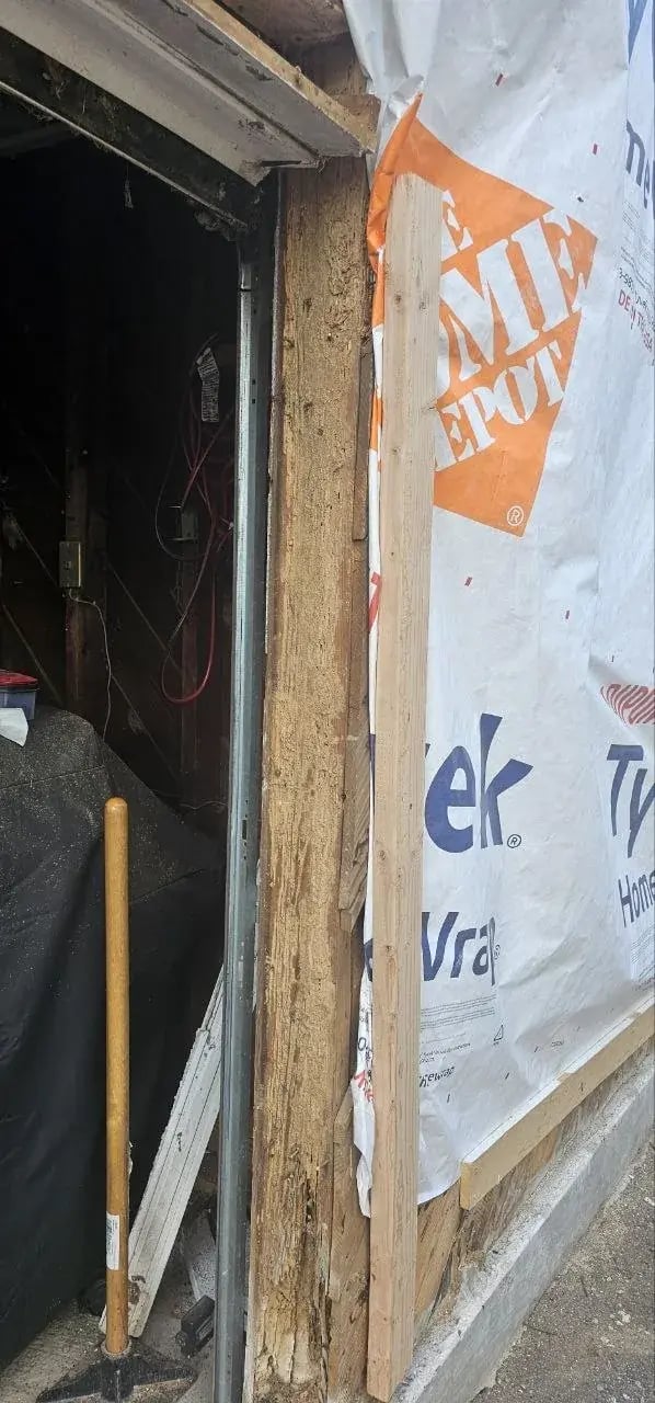 Damaged framing next to the garage door