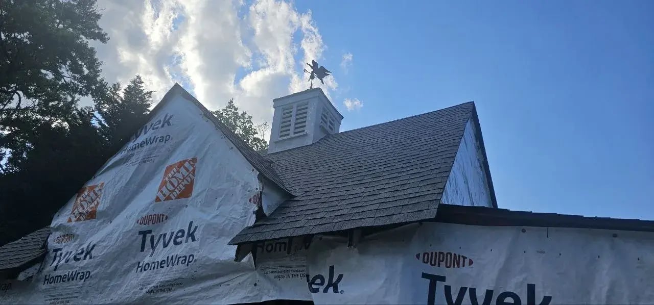 New roof shingles and house wrap on the garage