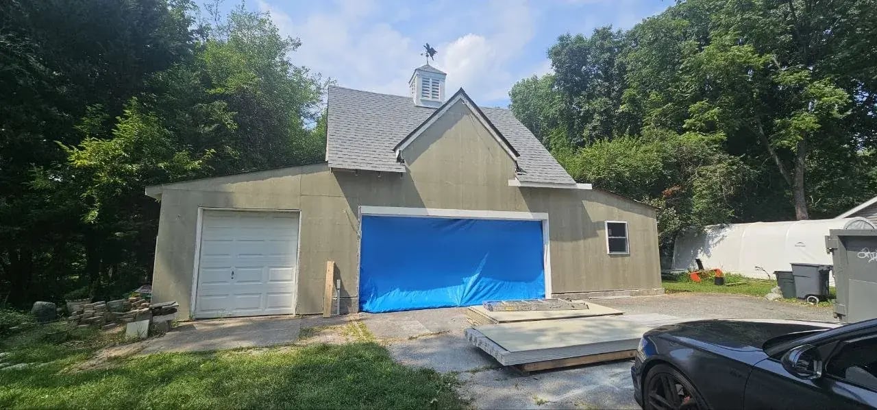 Primed fiber cement siding on the front of the garage