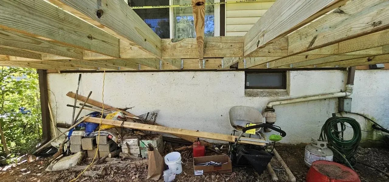 New pressure-treated joists hung on the ledger board
