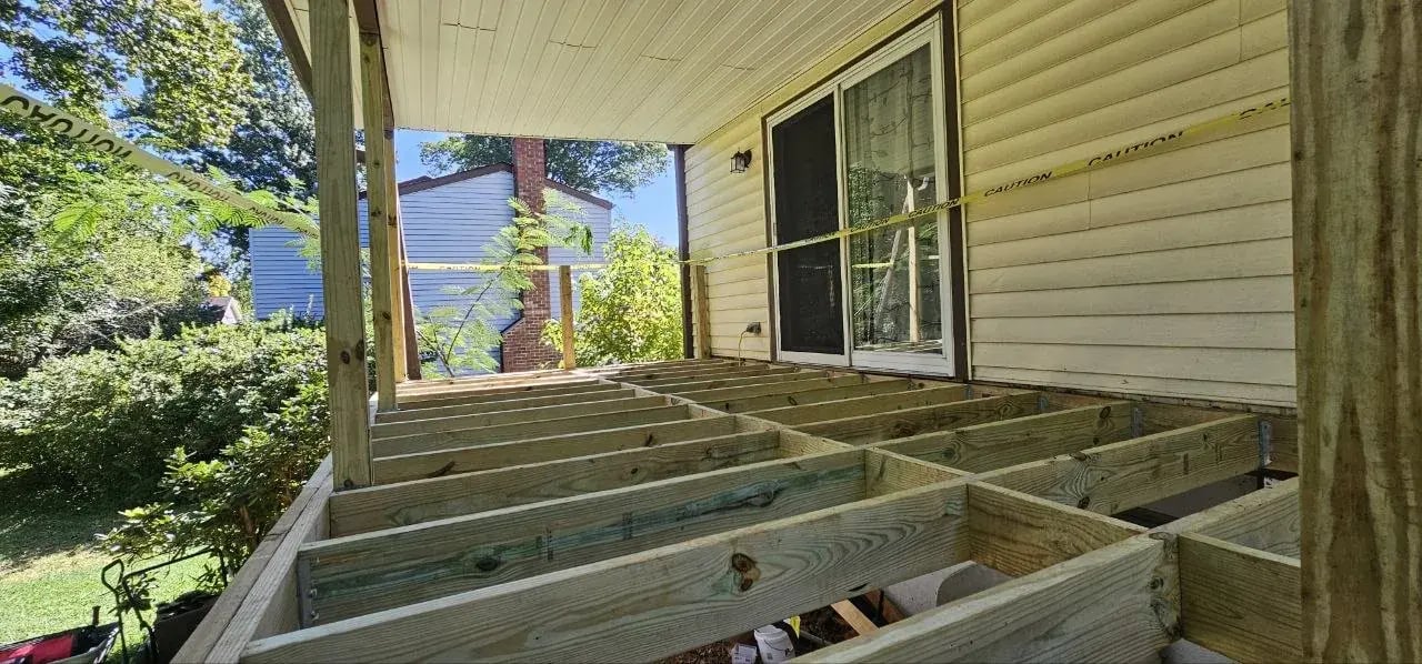 New pressure-treated deck joists under the covered roof