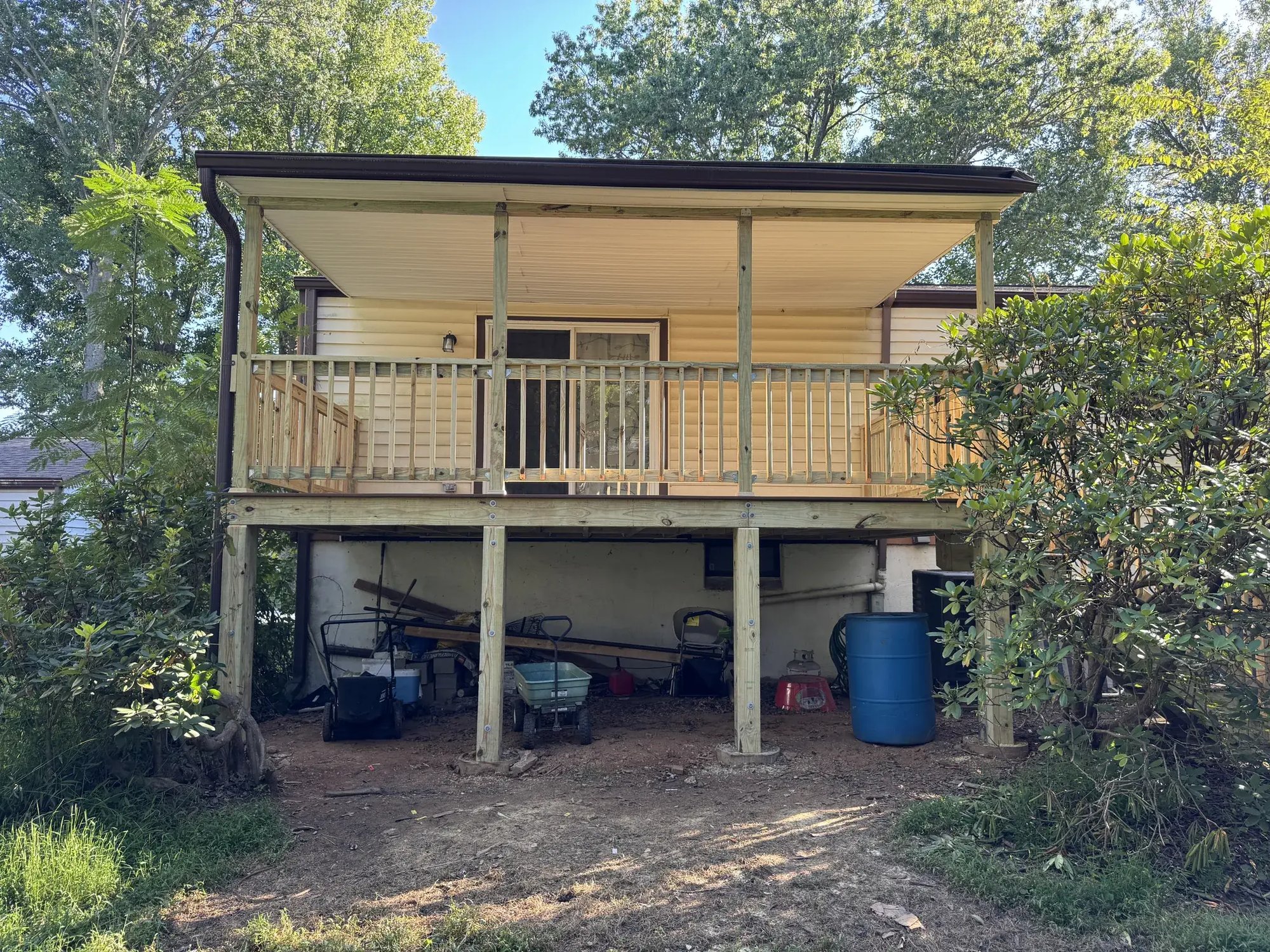 New covered deck in Columbia, MD before painting, view from the yard on a sunny day