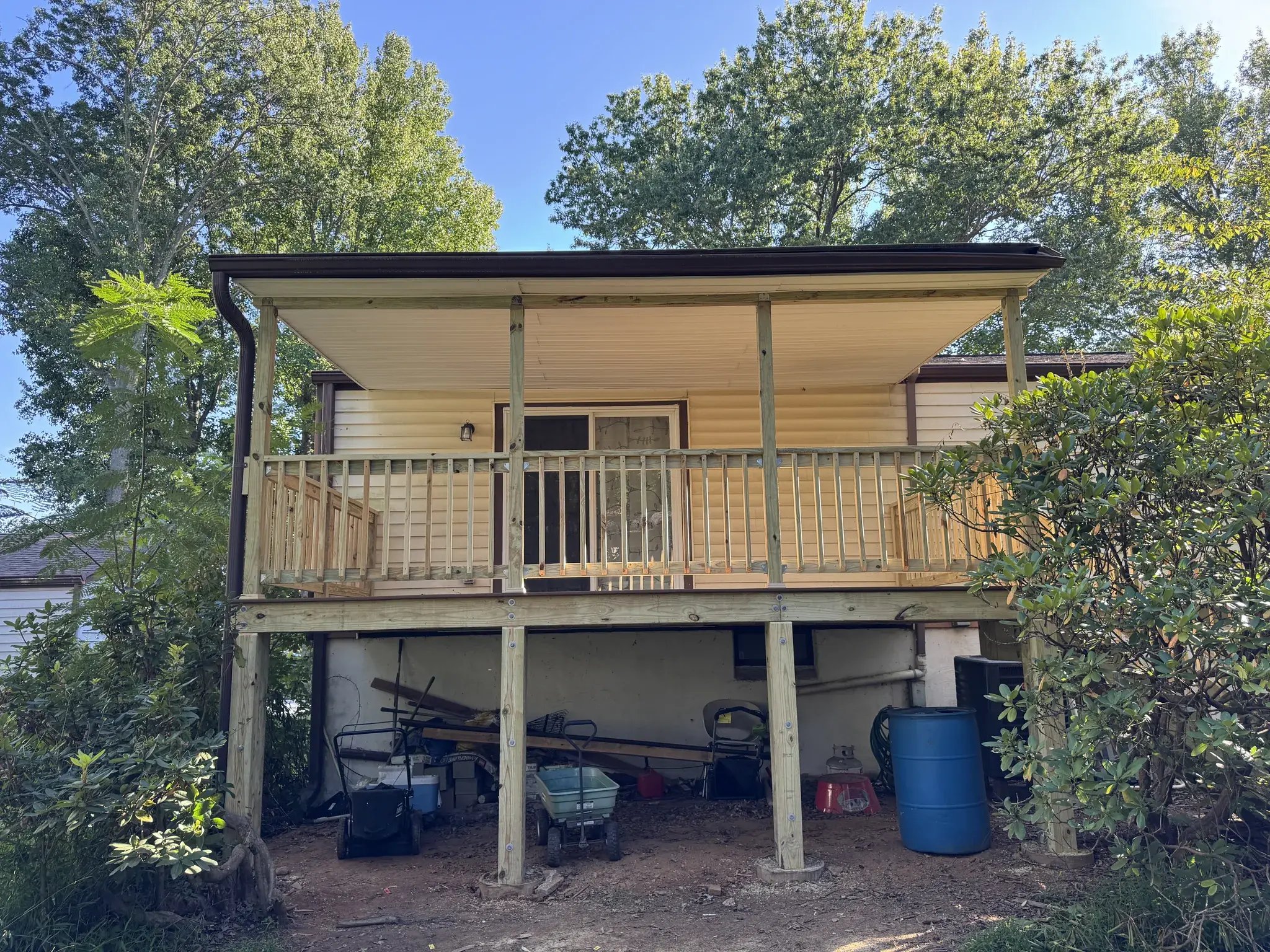 New pressure-treated deck frame and railings under the covered roof