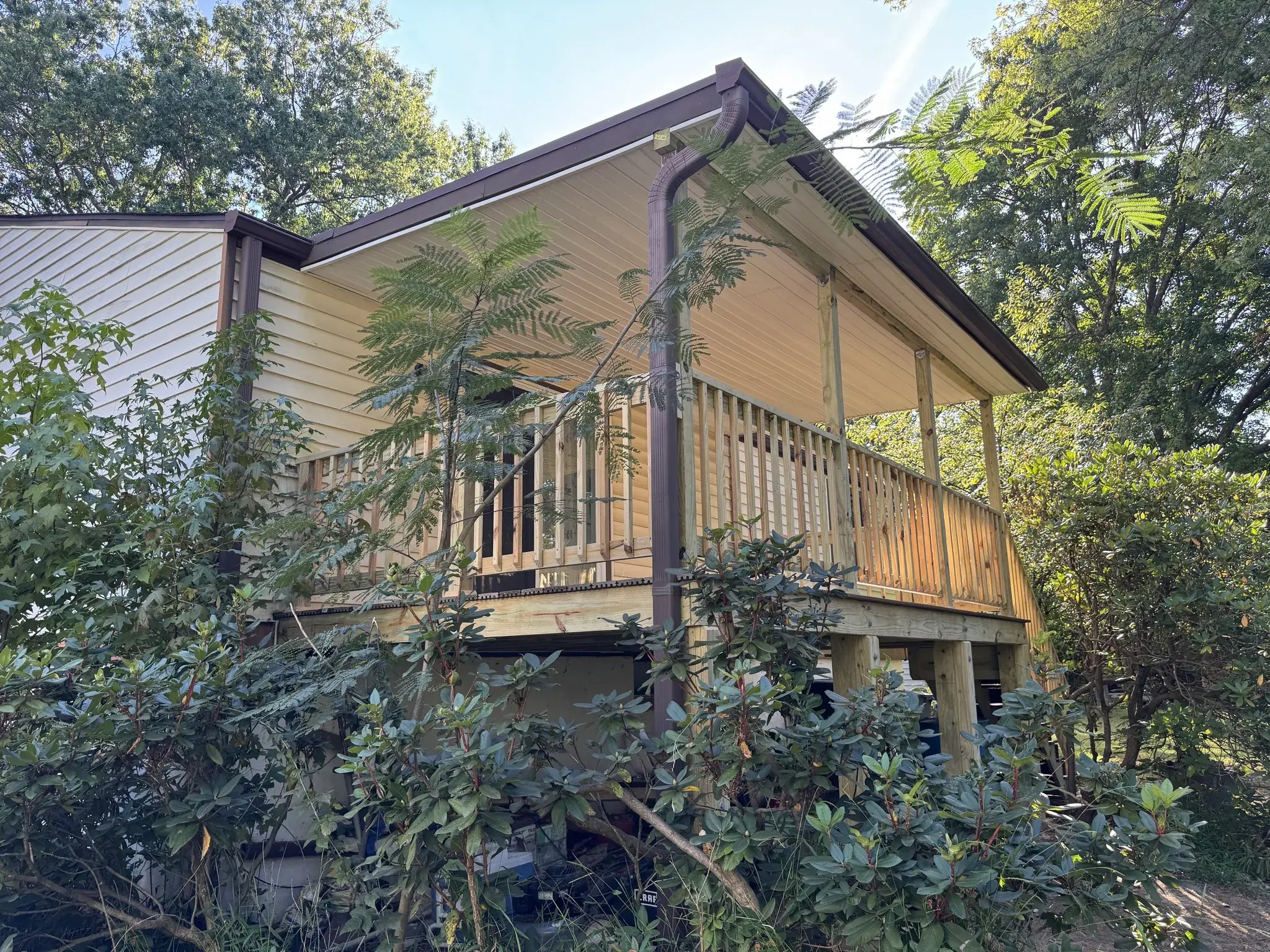 Side view of the new covered deck among the trees