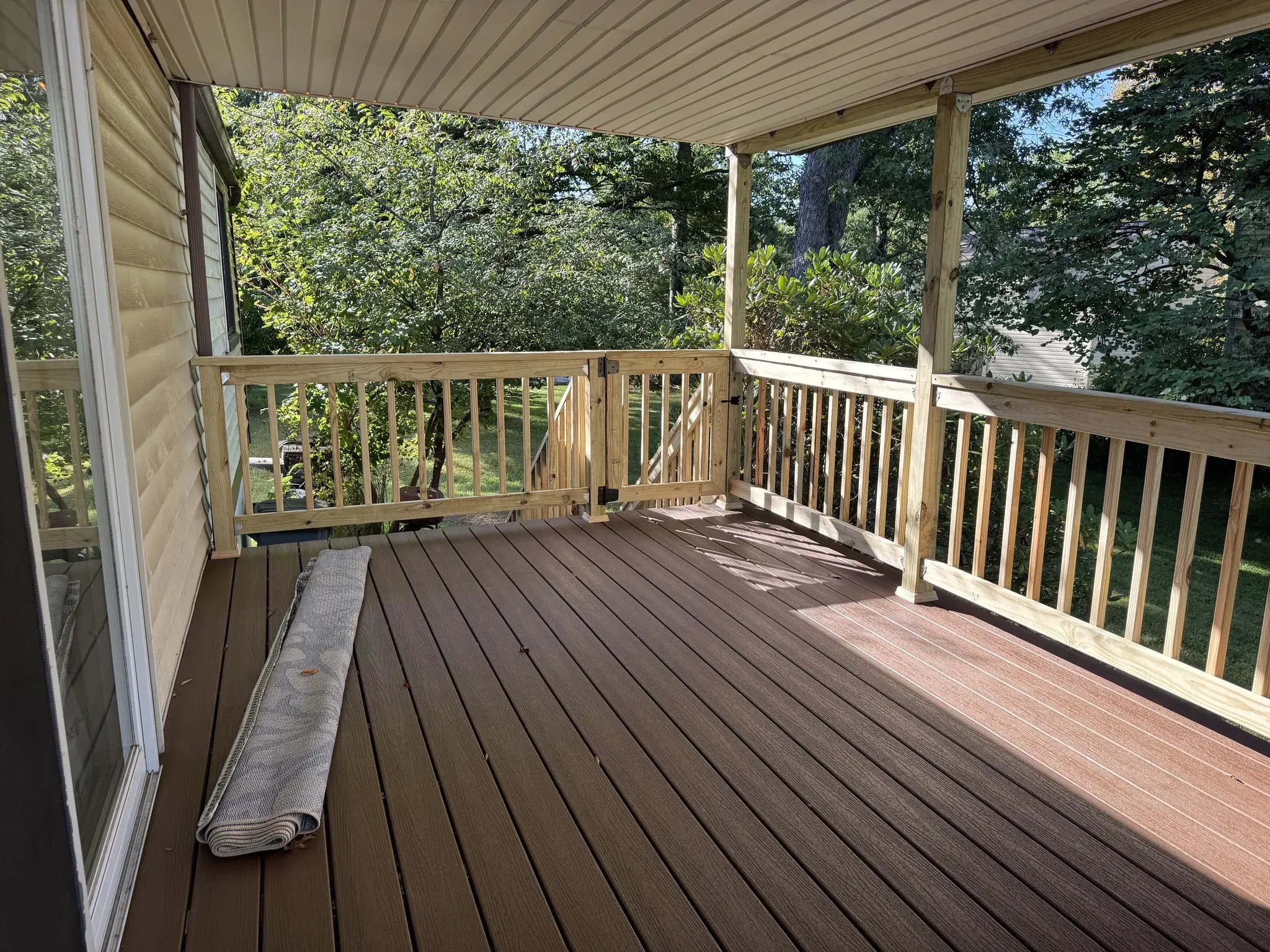 Covered deck with new railings and composite decking, corner view