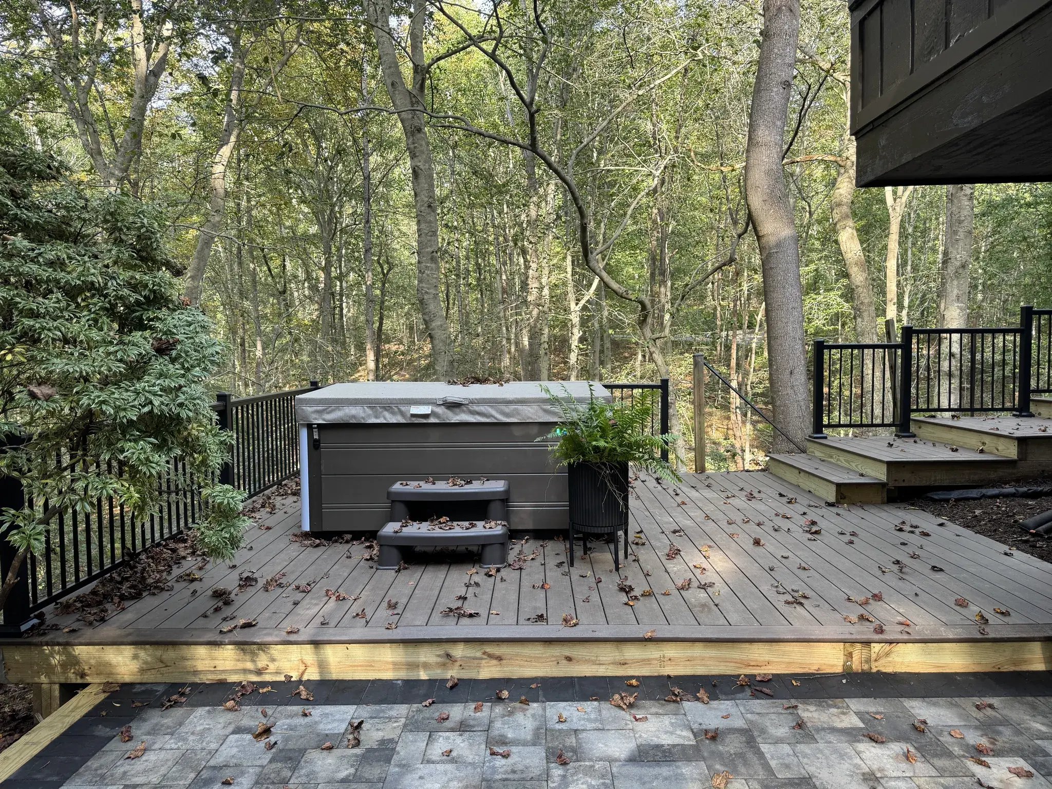 New composite hot tub deck above the paver patio
