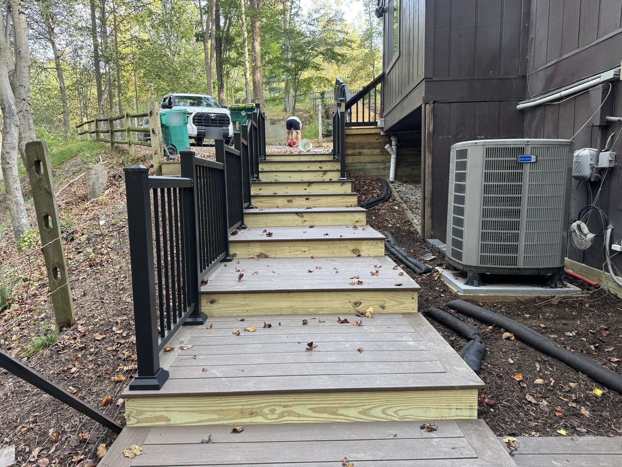 Rebuilt stairs from the parking area with black railings
