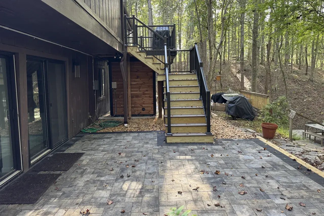 New paver patio at the sliding doors with new stairs to the upper deck
