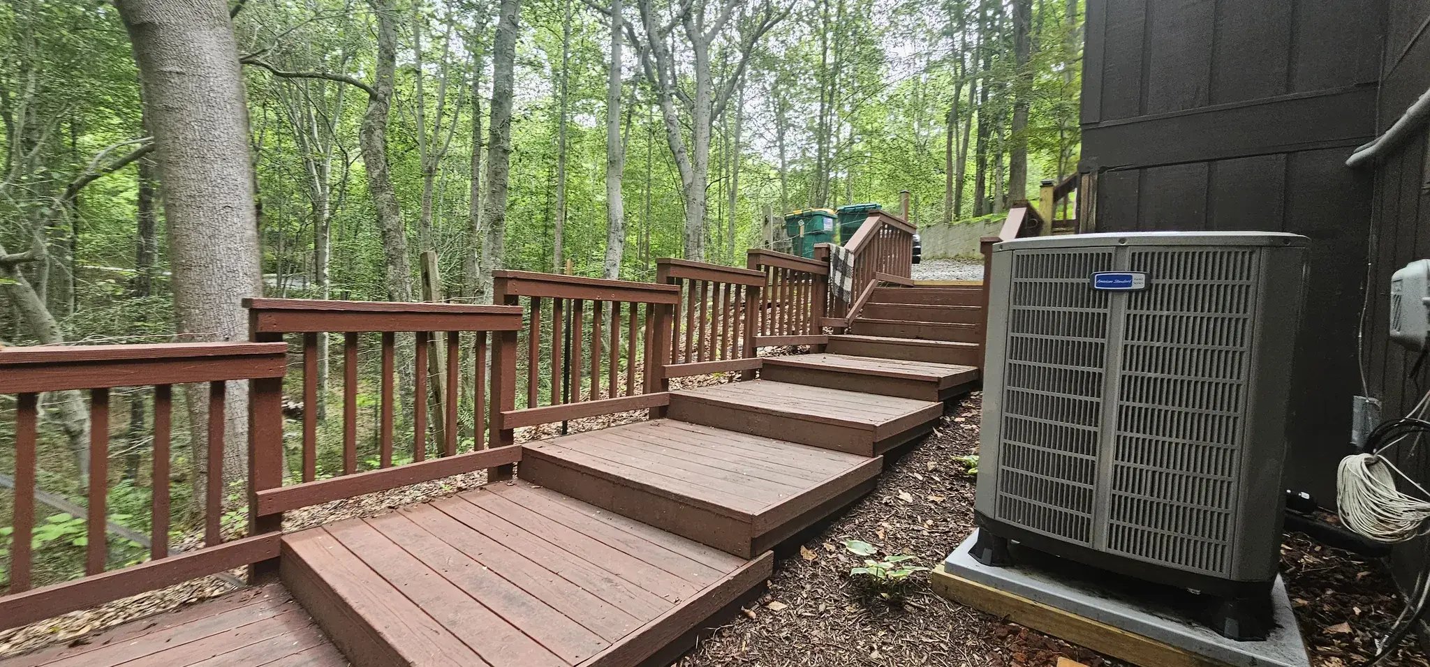 Old wood steps along the house next to the AC unit