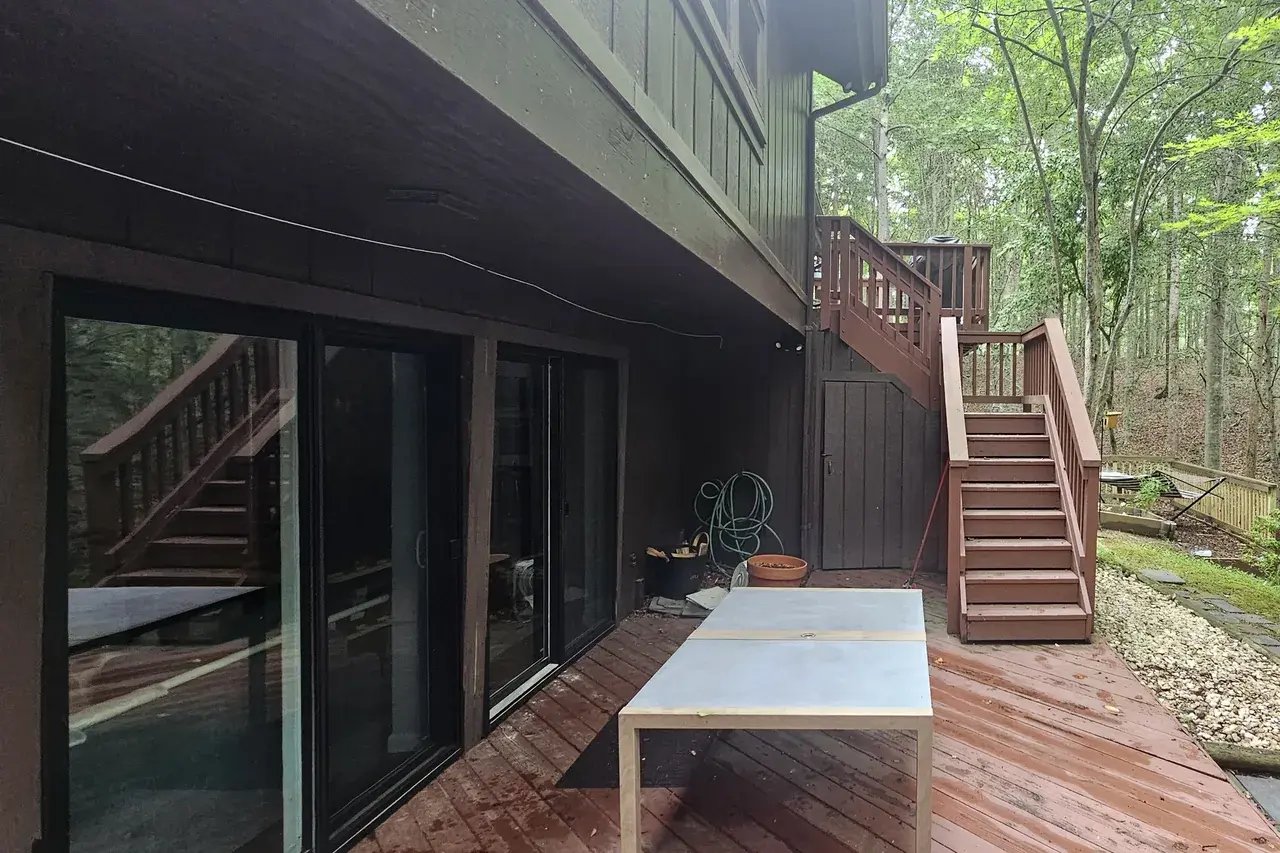 Old red wood deck at the sliding doors in Fairfax Station, VA before renovation