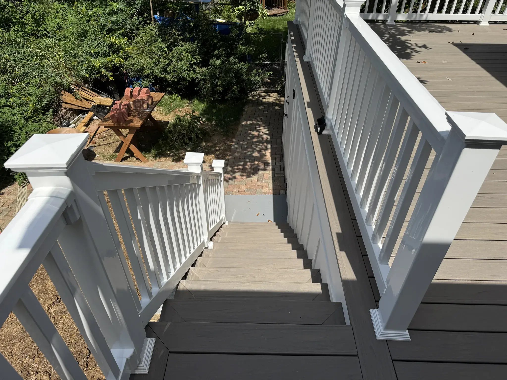 New stairs from the deck with white railings