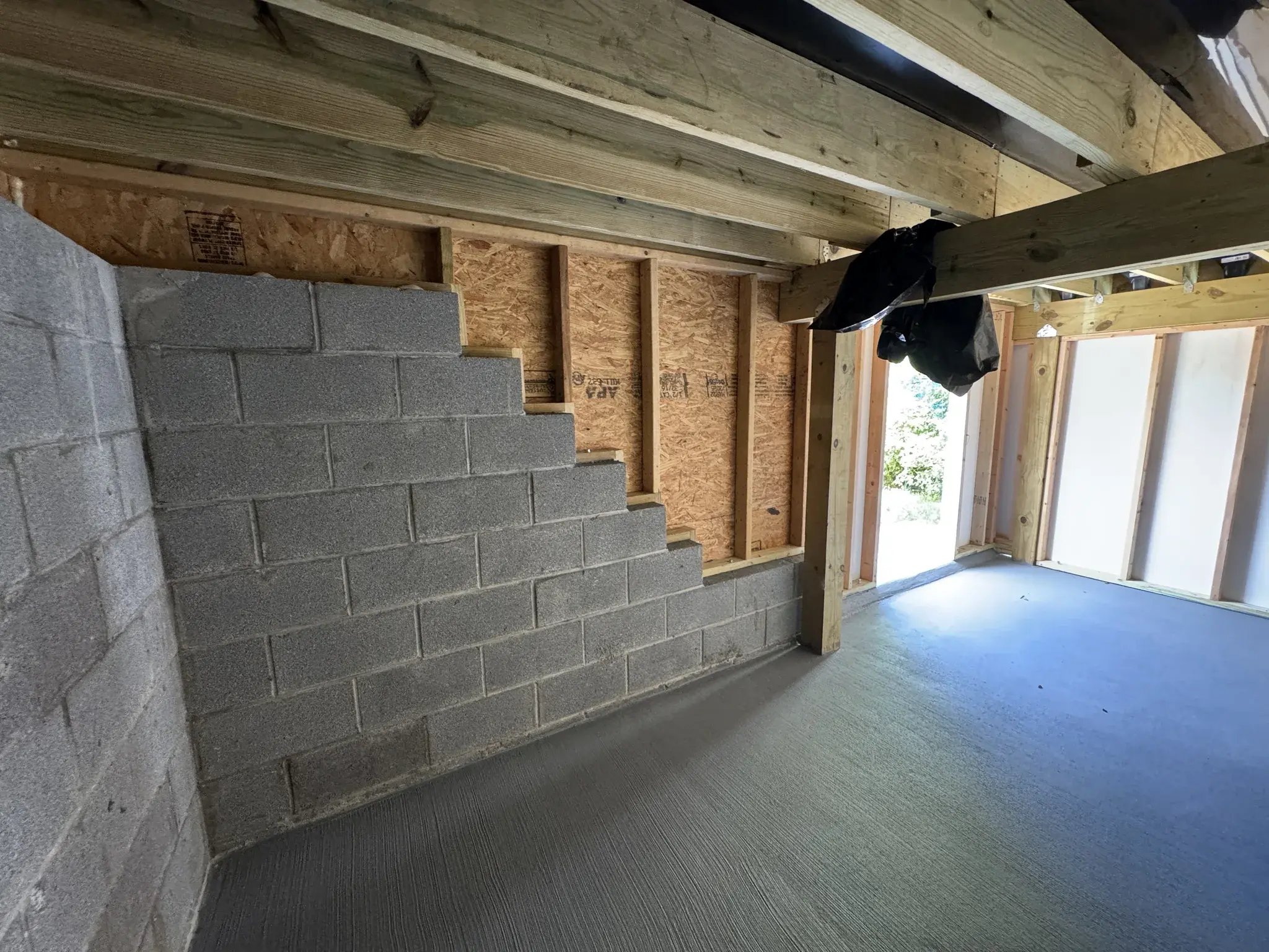 Storage room with a block retaining wall and concrete floor