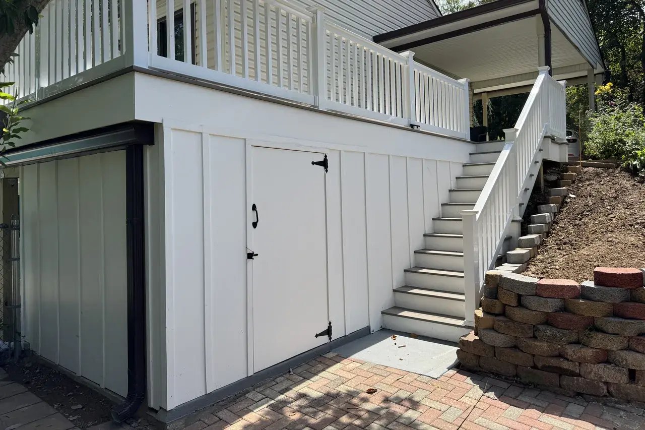 New deck with a storage room underneath and new stairs with white railings