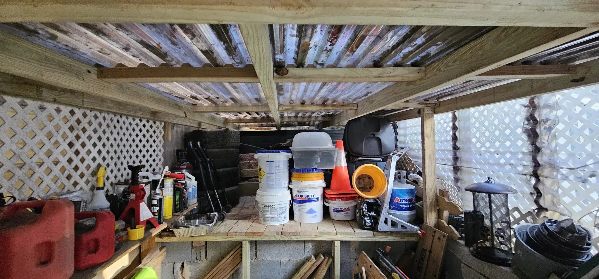 Cluttered old storage space under the deck
