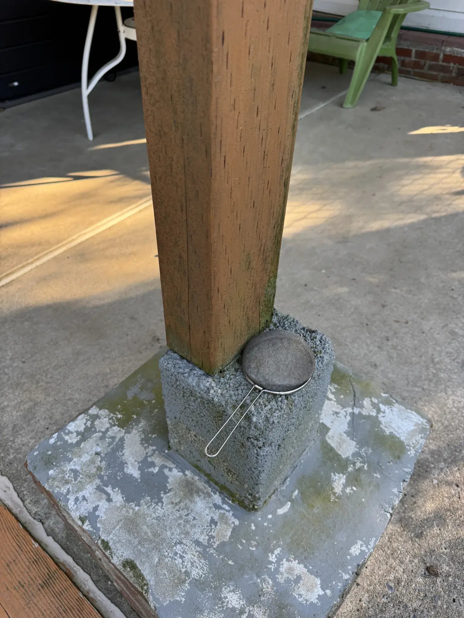 Old wood post on a cracked concrete base
