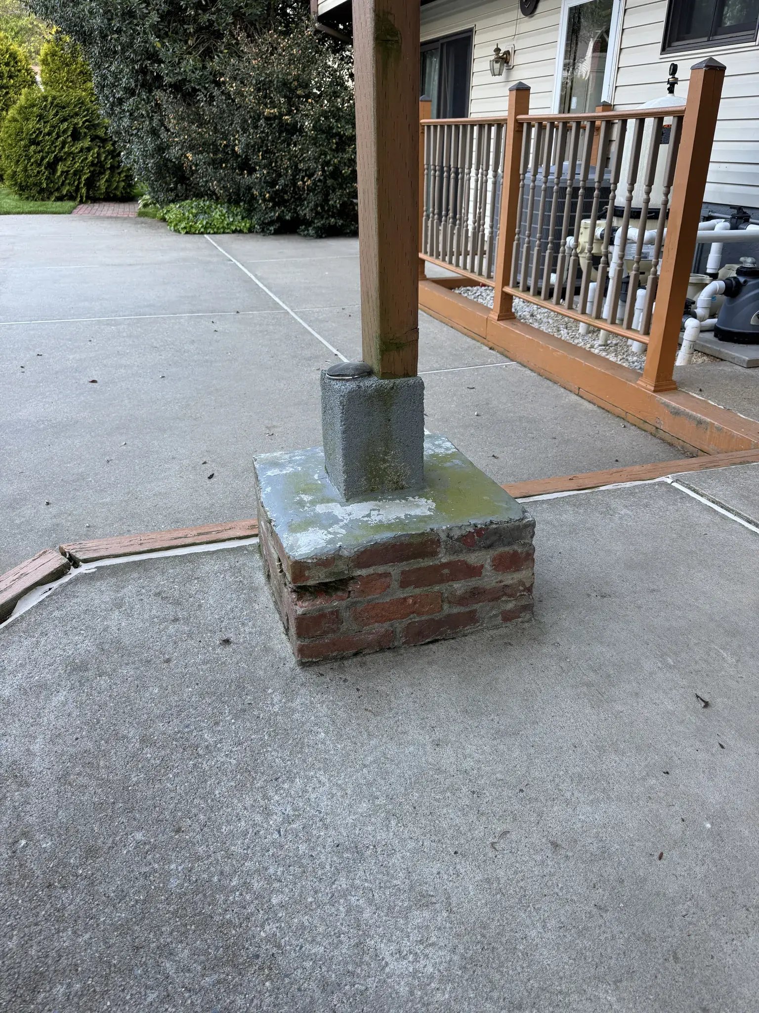 Old post on a brick pier at the back patio