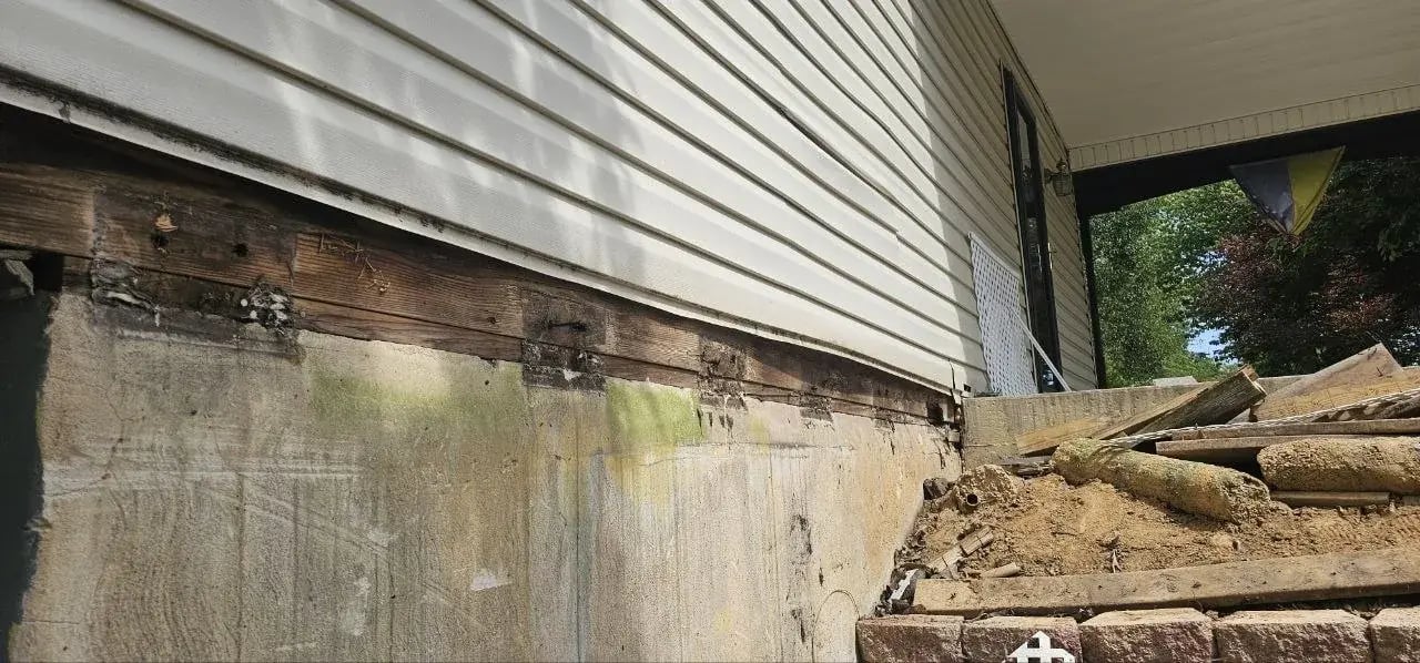 Rotted wood along the old block wall