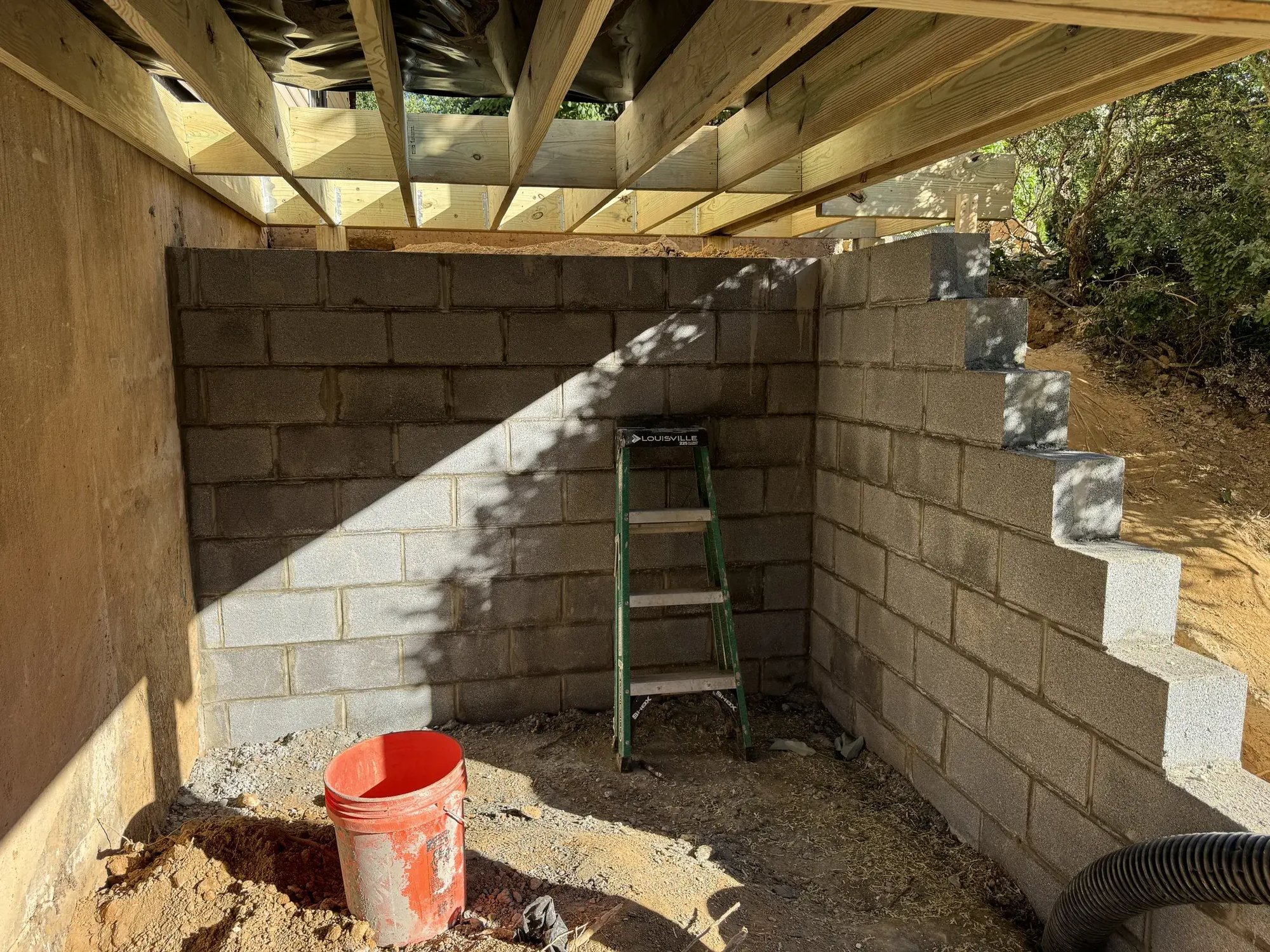 New concrete block retaining wall for the storage room
