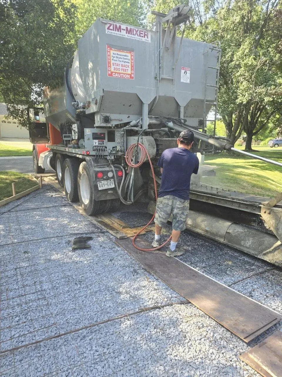 Concrete truck pouring the new driveway