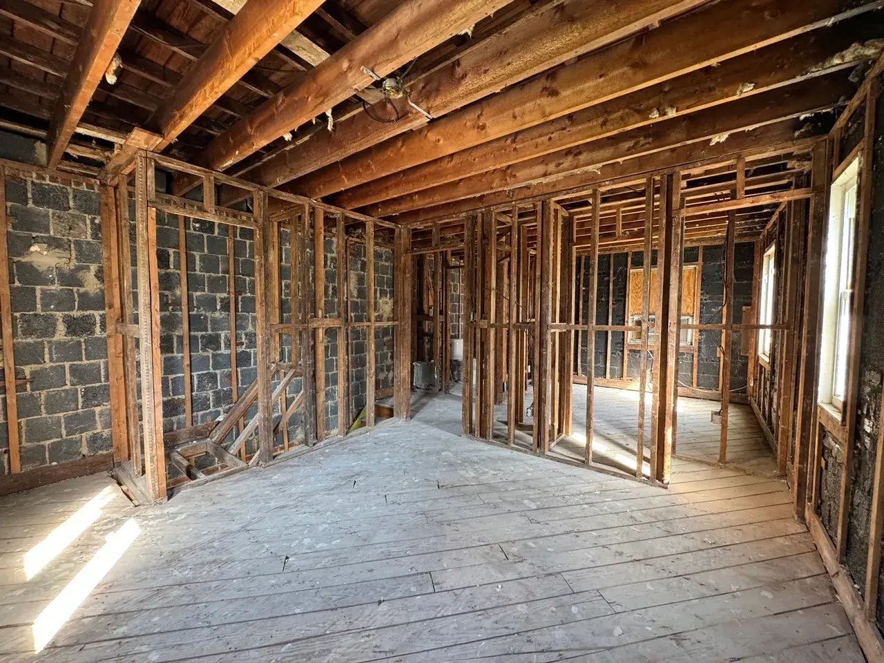House stripped to wood framing and joists during full interior demolition
